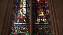 Religious scenes inside of a church view stained glass windows 