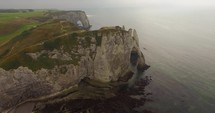 Aerial view of Etretat Aval cliff, rocks and natural arch landmark.	