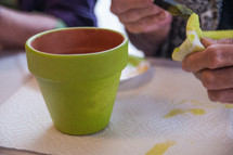 Painting a terracotta pot.