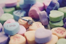 Valentines conversation hearts and diamond engagement ring 