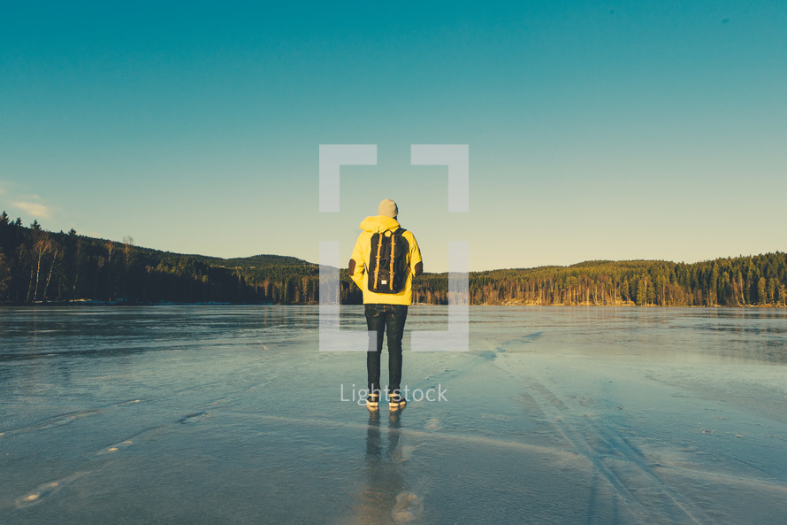 a man standing on a frozen lake 