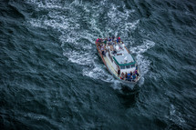 crowded boat on the ocean 