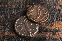 Two Small Copper Coins or Widows Mites Isolated on a Wood Background