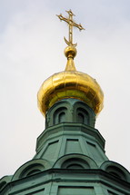 gold cross on a steeple 