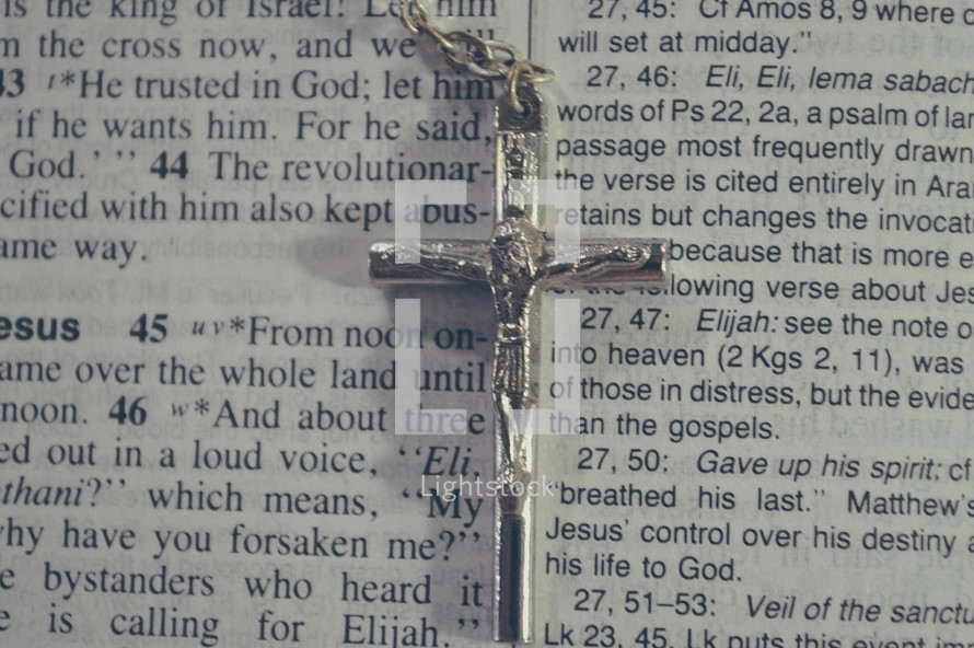 crucifix on the pages of a Bible 