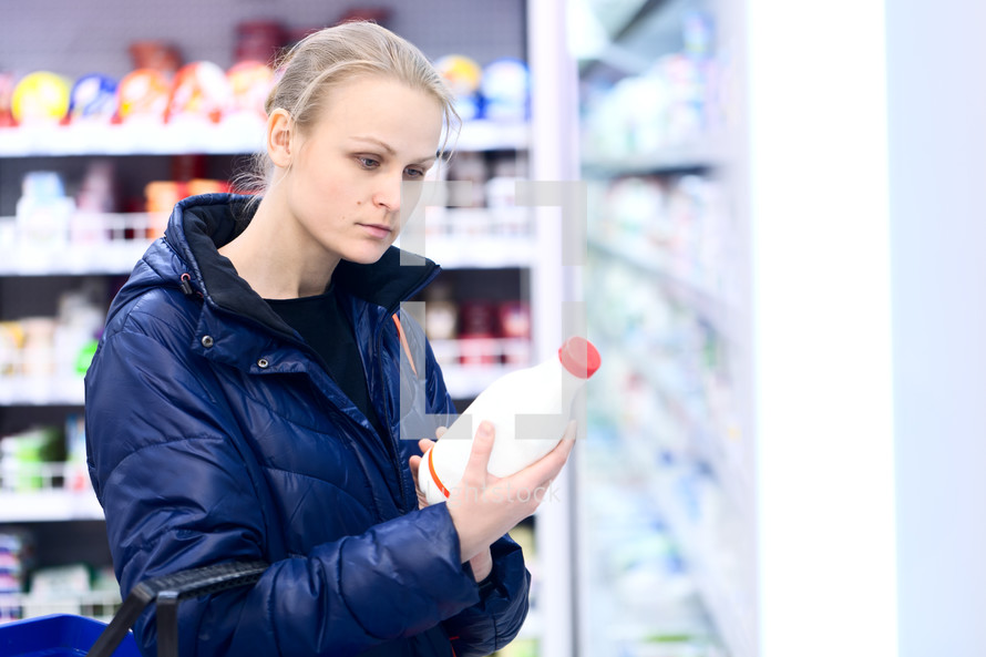 Woman in grocery holding milk