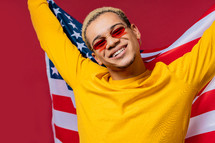 Happy man with national USA flag on red background