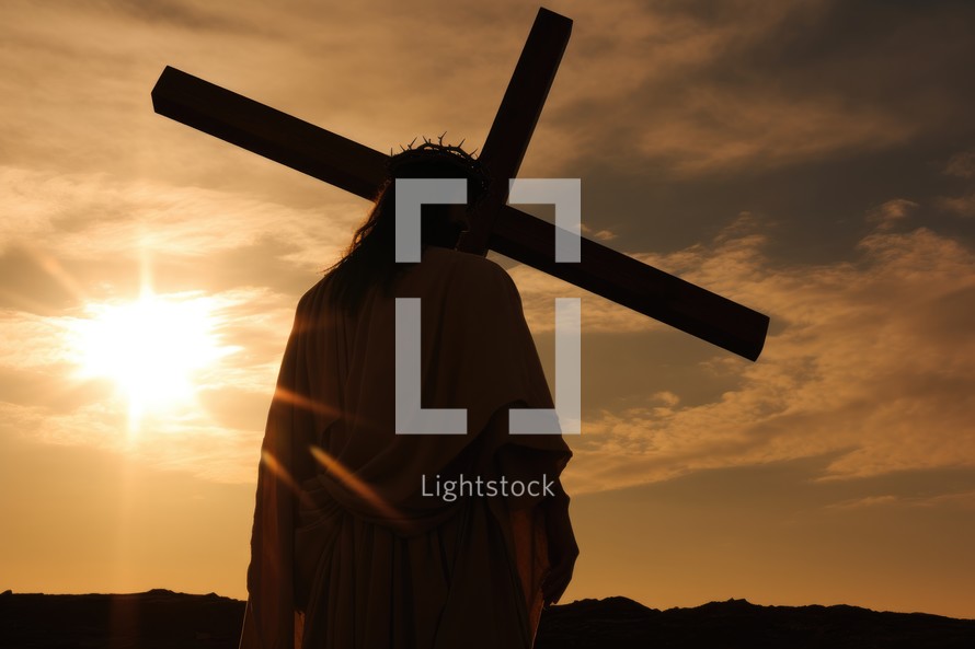 Jesus Christ holding the cross at sunset