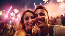 Happy young couple taking selfie with fireworks in the background 