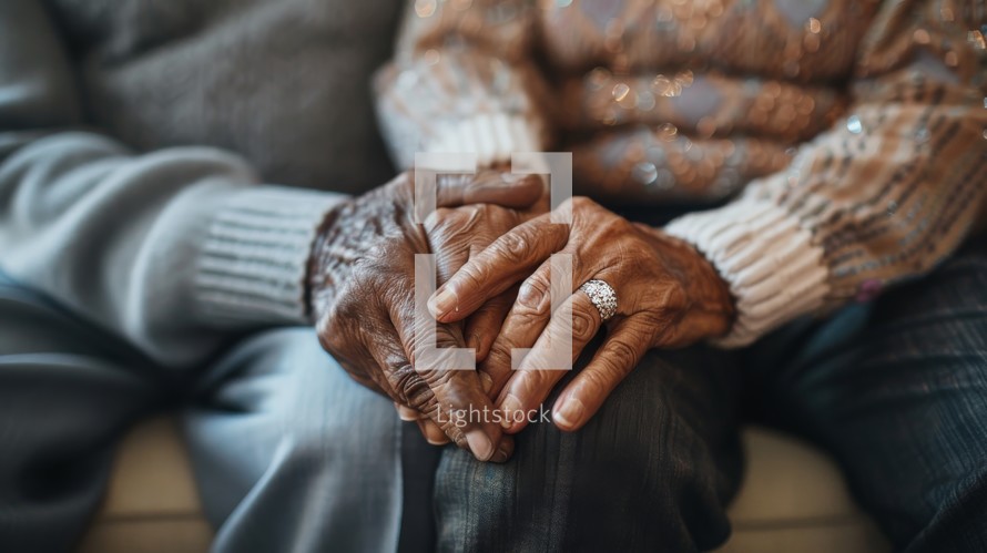 An older person is holding the hands of a younger person, showing a connection and support between generations.