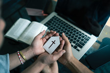 Man and woman holding paper church icon praying with computer laptop, Church services online concept, Online church at home, family christian concept.