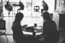 two women in a coffee shop studying their bibles