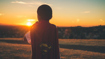 Boy facing the sun, putting on a superman cape.
Imagination | Dreaming | Destiny | Vision| Heroes | Justice | Kids Ministry | Movies | Heroes | Bravery | Brave | Courage | Courageous | Strong | Strength | Stand | Determination | Persevere | Sermon Series |
