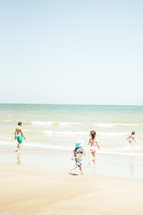 children running on a beach 