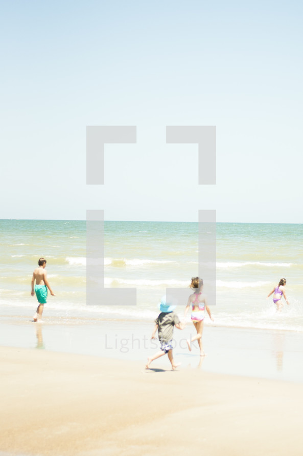 children running on a beach 