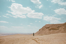 a woman walking in a desert in Israel 