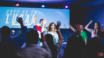worship leaders on stage singing 