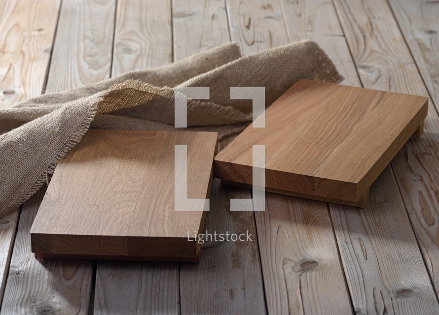 Two empty chopping boards for dishes on wooden background