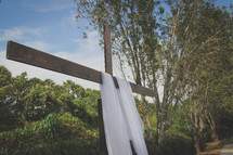 white shroud on a wooden cross