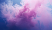 Pink and blue cloud of ink in water on a blue background.