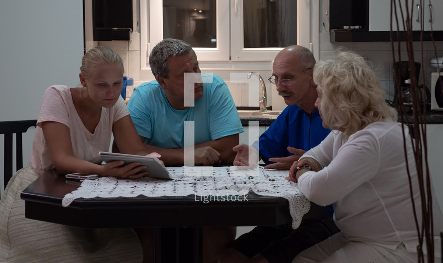 family talking around the kitchen table 