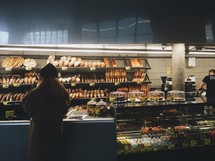 a woman shopping at a bakery 