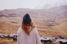 woman looking at a snow capped mountain peak 