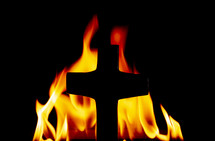 cross silhouette in front of flames 