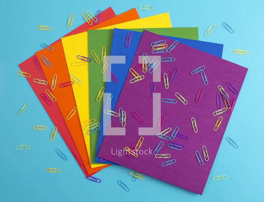 rainbow colored paperclips and paper 