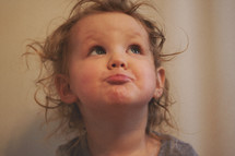 toddler girl with a silly face 