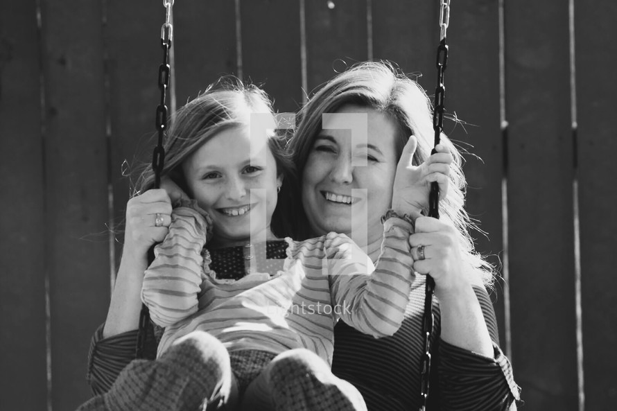 mother and daughter on a swing 