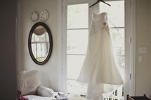 Bridal gown hanging in a window