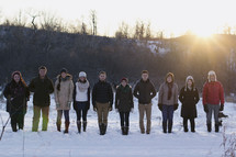 friends standing in snow outdoors