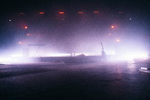 An empty stage lit up with hazy lighting.