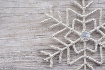 snowflake decoration on wood background 