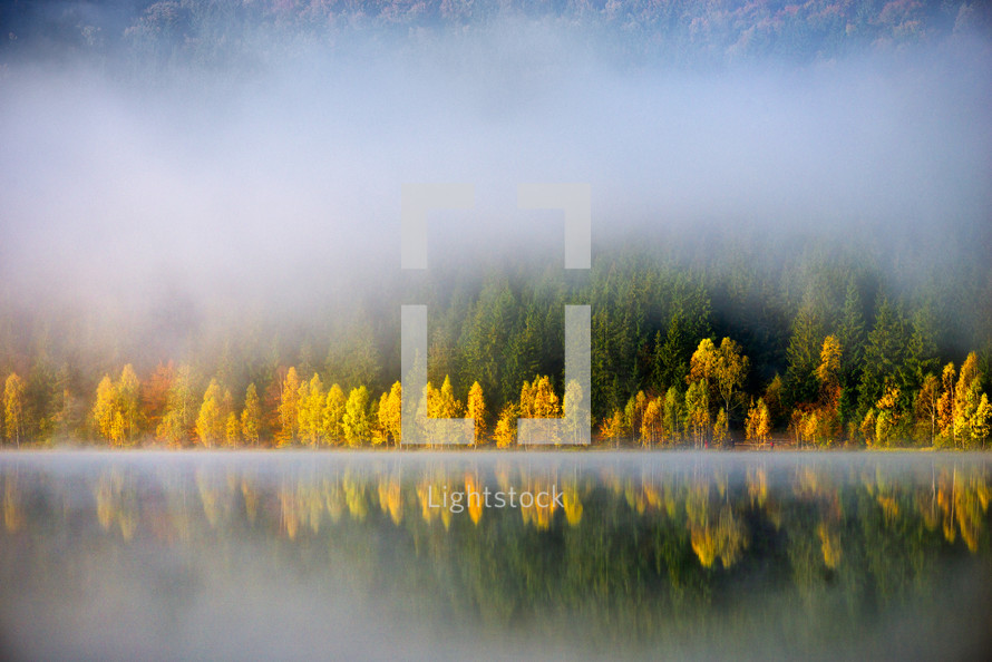 mist and fog over a lake in autumn 