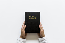 man holding a Holy Bible 