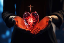 Close up of woman hands holding luminous heart with christian cross on dark background