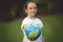 girl child holding a soccer ball 