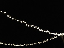 string of lights hanging outdoors at night 