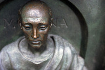 A bronze sculpture of a monk.