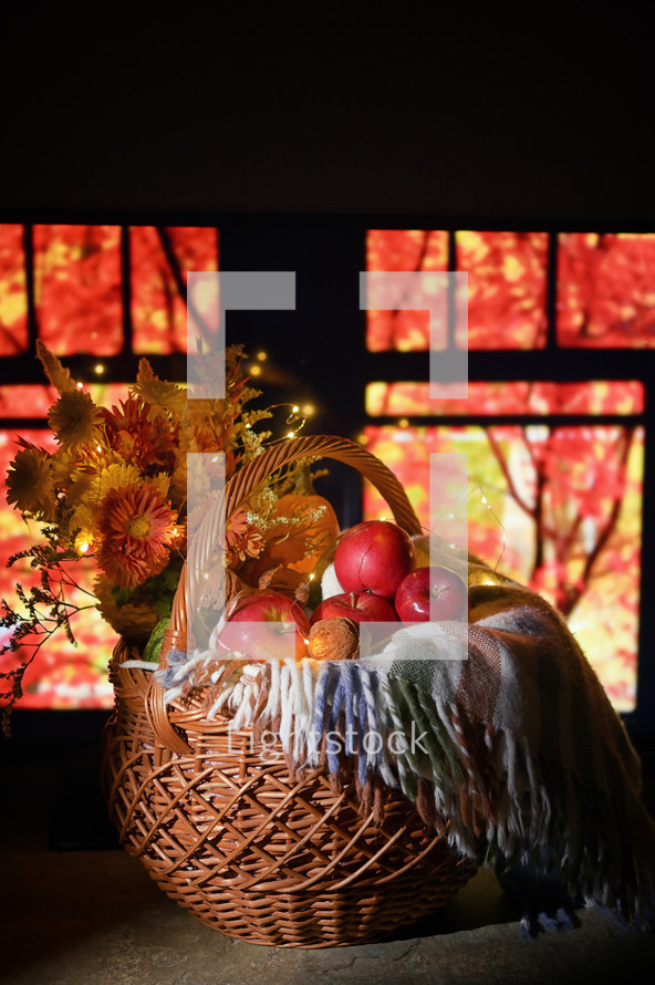 Autumn Basket at Window and red trees in background