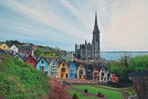 St. Colman's Cathedral And Colored Houses In Cobh, Ireland in Summer