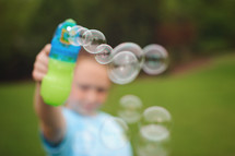 blowing bubbles outdoors 