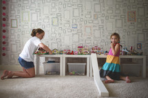 girls playing with legos in a playroom 