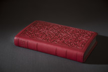 red Bible on a table 
