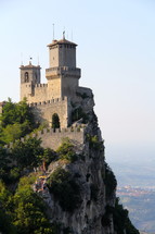 a fortress and castle on a mountainside 
