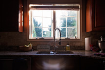 kitchen sink in front of a window 