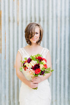 Bride holding a wedding bouquet galvanized steel florals white dress wedding