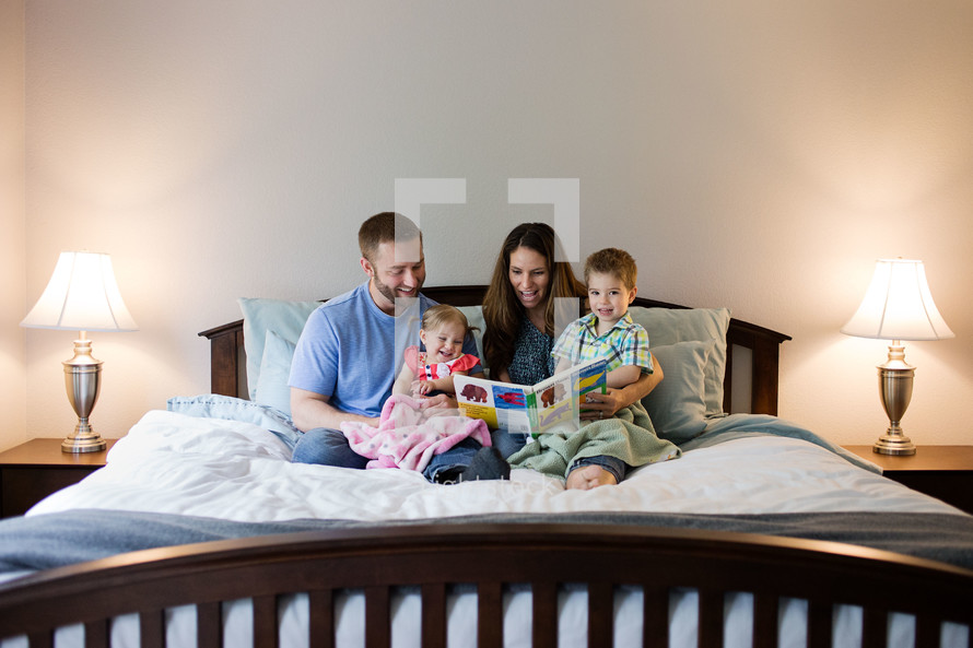 family reading together in bed 